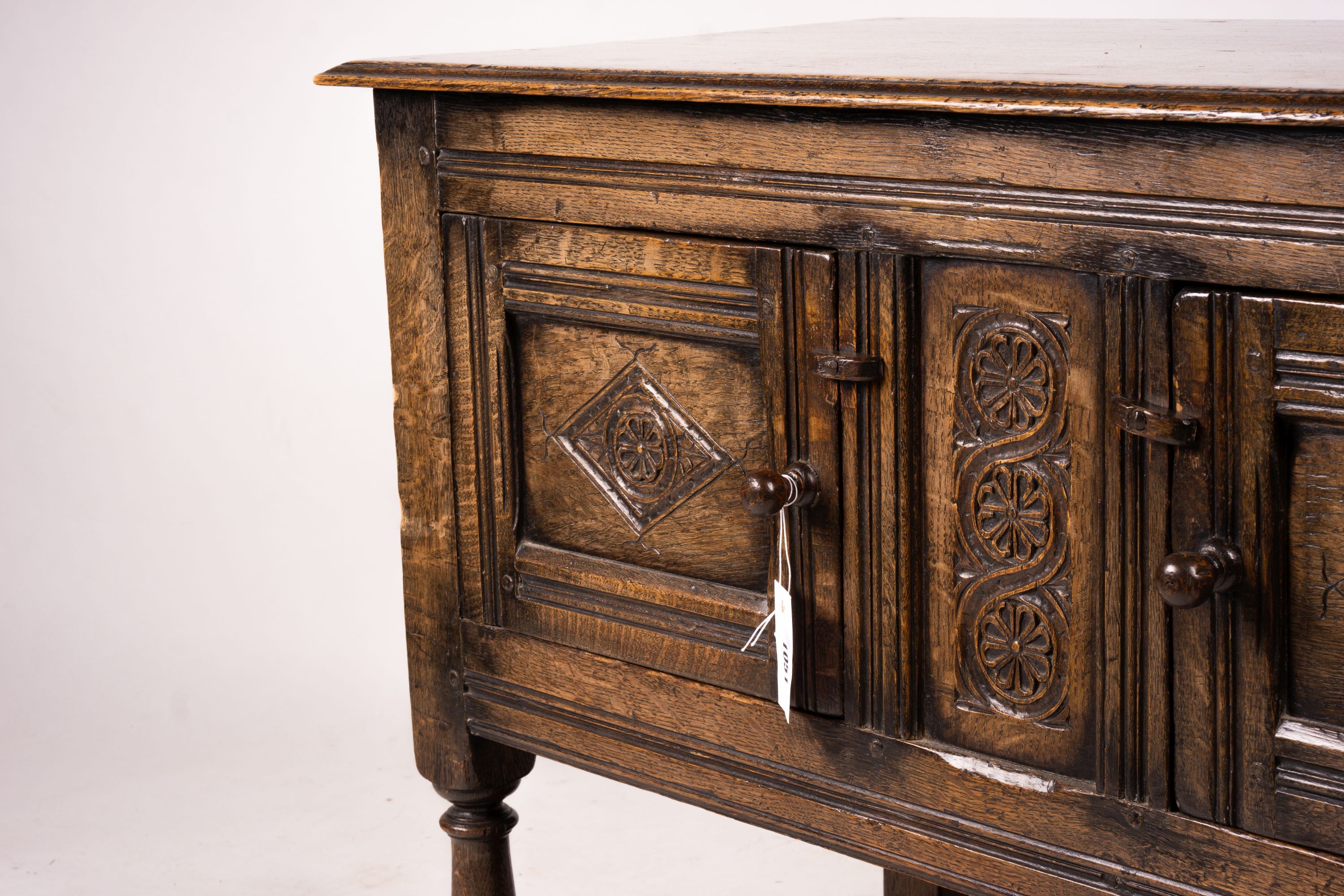 An 18th century style oak two door low cupboard, width 106cm, depth 50cm, height 78cm